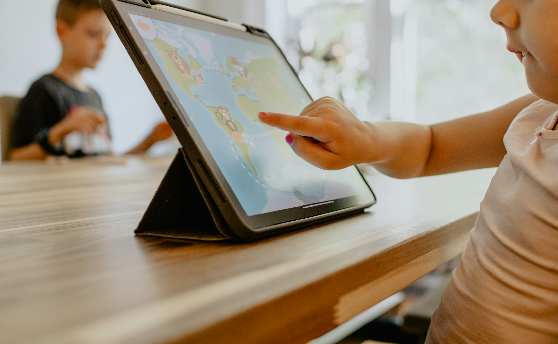A child learning with a tablet at a desk